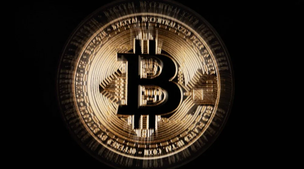 شاشة تعرض شعار عملة البتكوين (أ.ف.ب)