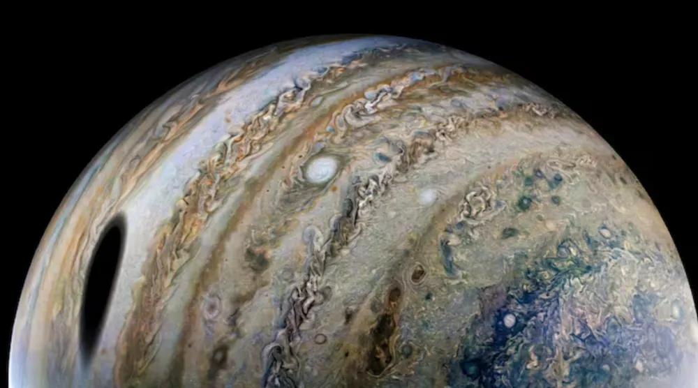 An enhanced-color image, using raw data from the JunoCam instrument aboard NASA's Juno spacecraft, shows the planet Jupiter, with a shadow of its moon Ganymede on the left, released by NASA on April 21, 2022. NASA/JPL-Caltech/SwRI/MSSS/Image processing by Thomas Thomopoulos/Handout via REUTERS 