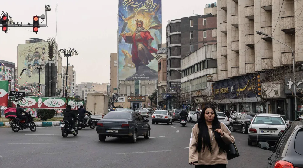 Traffic moves through a street in Tehran on February 7, 2026. (Photo by ATTA KENARE / AFP)