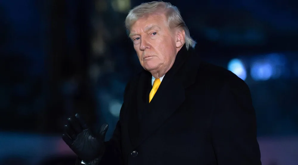 President Donald Trump waves to the media as he walks on the South Lawn upon his arrival to the White House, Monday, Feb. 9, 2026, in Washington. (AP Photo/Jose Luis Magana)