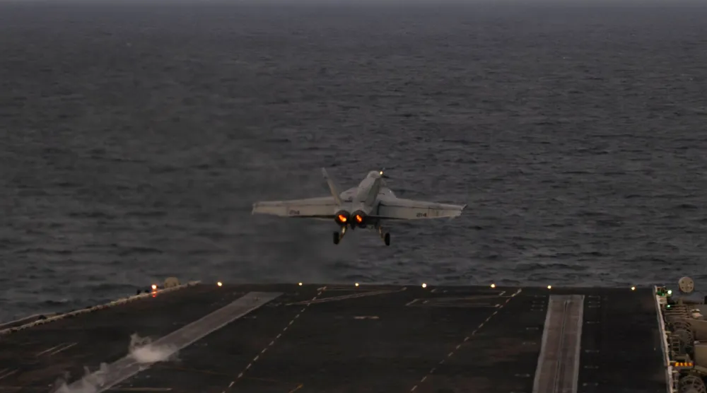 In this handout photograph released by the US Navy on February 5, 2026, an F/A-18E Super Hornet, attached to Strike Fighter Squadron (VFA) 14, launches from the flight deck of Nimitz-class aircraft carrier USS Abraham Lincoln in the Arabian Sea on February 3, 2026. (AFP / US Navy / Mass Communication Specialist Seaman Zoe Simpson)