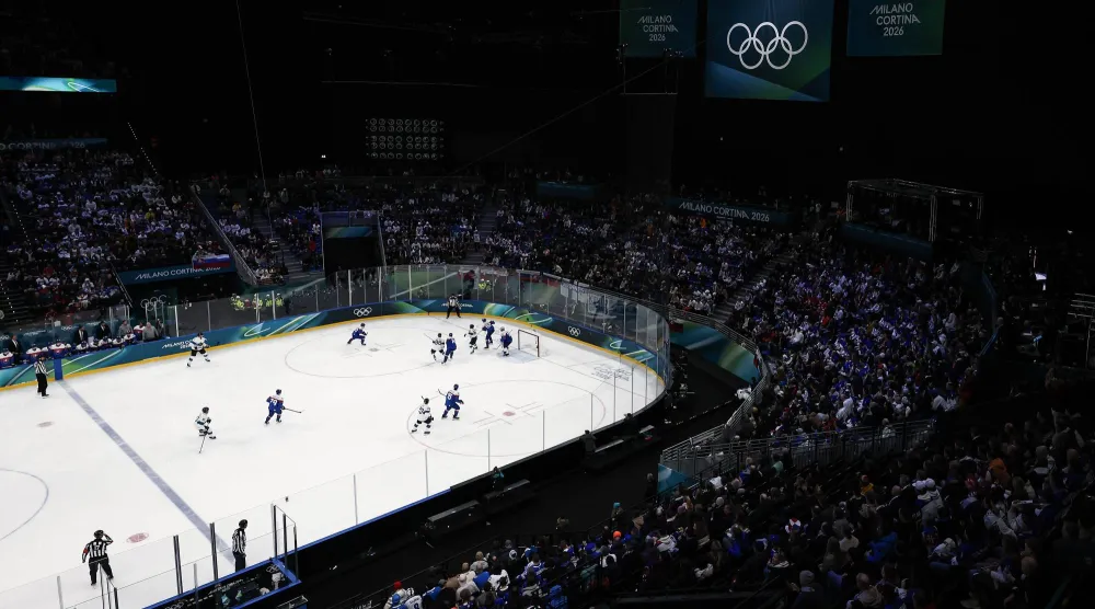 Finland players vie for the puck against Slovakia players during the Men's Preliminary Round match Slovakia against Finland of the Ice Hockey competitions, at the Milano Cortina 2026 Winter Olympic Games in Milano, Italy, 11 February 2026. (EPA)