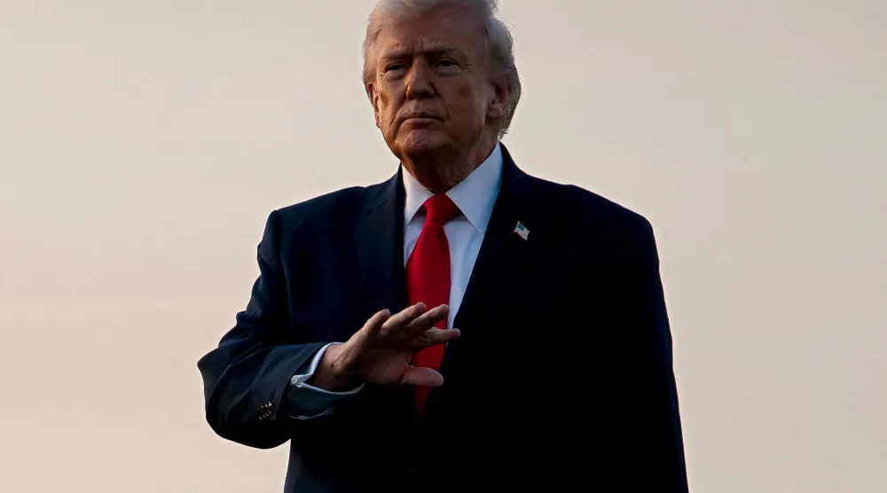 WEST PALM BEACH, FLORIDA - FEBRUARY 13: US President Donald Trump gestures to members of the media after exiting Air Force One at Palm Beach International Airport on February 13, 2026 in West Palm Beach, Florida. Nathan Howard/Getty Images/AFP
