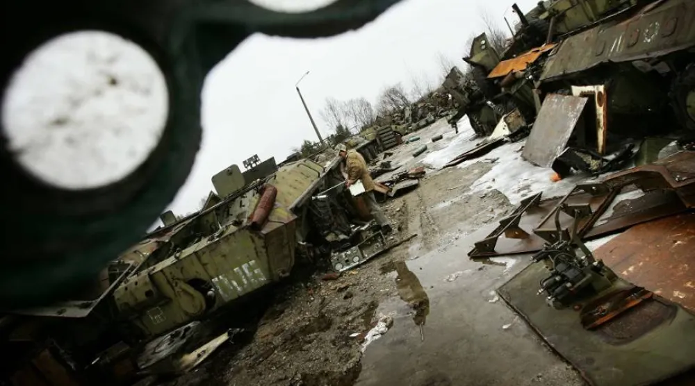 عامل يقيس مستويات الإشعاع في مقبرة بحثاً عن معدات ملوثة استخدمت خلال كارثة تشيرنوبل (رويترز)