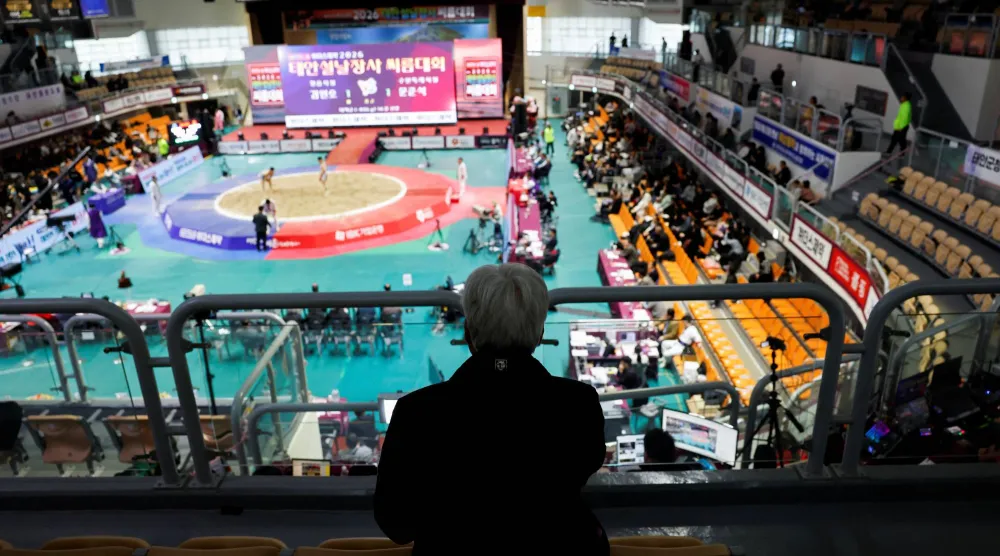 An elderly spectator watches a ssireum match during a Lunar New Year Ssireum championship at the Taean Complex Indoor Gymnasium in Taean, South Korea, February 14, 2026. (Reuters)