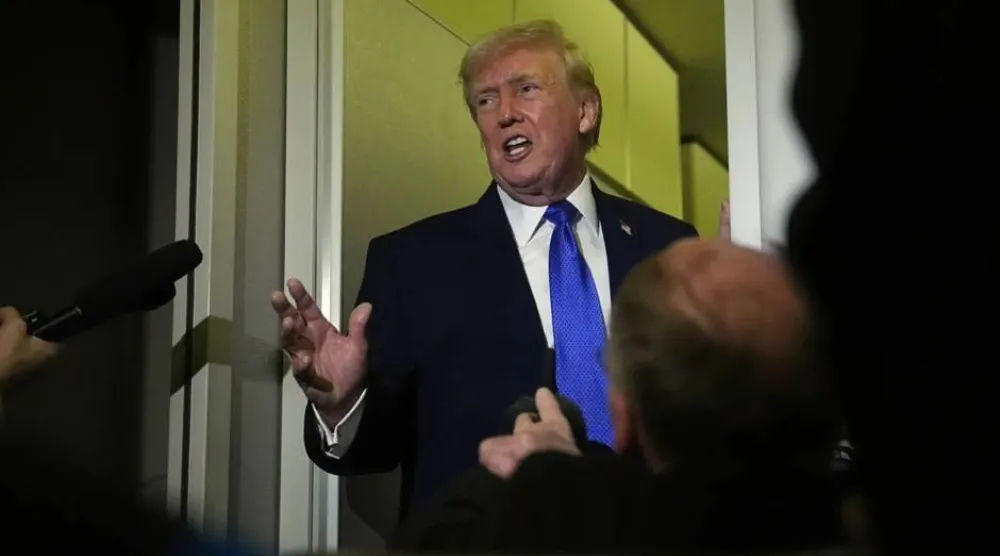 US President Donald Trump speaks aboard Air Force One (AP)