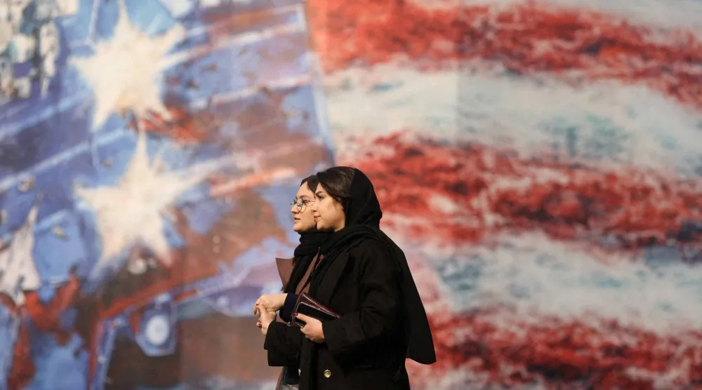 People walk past an anti-US billboard in Tehran, Iran, January 26, 2026. Majid Asgaripour/WANA (West Asia News Agency) via Reuters 