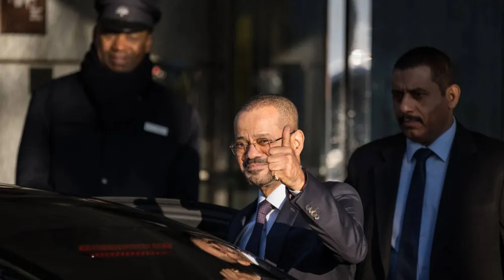 Oman's Foreign Affairs Minister Badr bin Hamad al-Busaidi gives a thumbs up as he leaves his hotel to reach Oman's ambassador residency for new round of talks between the United States and Iran to address Iran's nuclear program, in Geneva on February 26, 2026. (Photo by Fabrice COFFRINI / AFP)