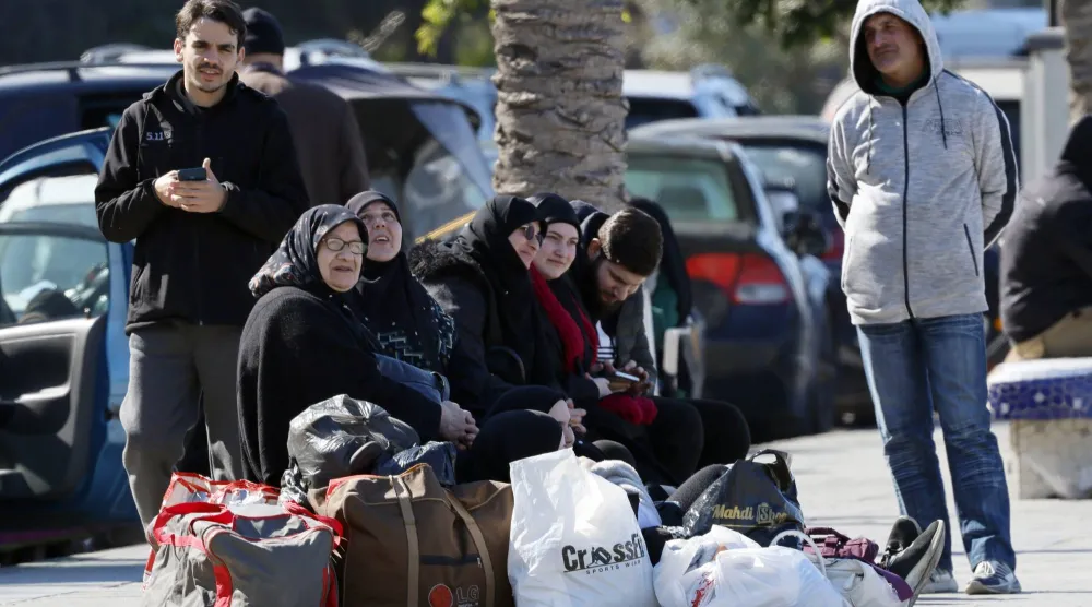 سكان نازحون من الضاحية الجنوبية يجلسون على طول كورنيش المنارة في بيروت 2 مارس 2026 بعد فرارهم من منازلهم عقب غارات إسرائيلية (إ.ب.أ)