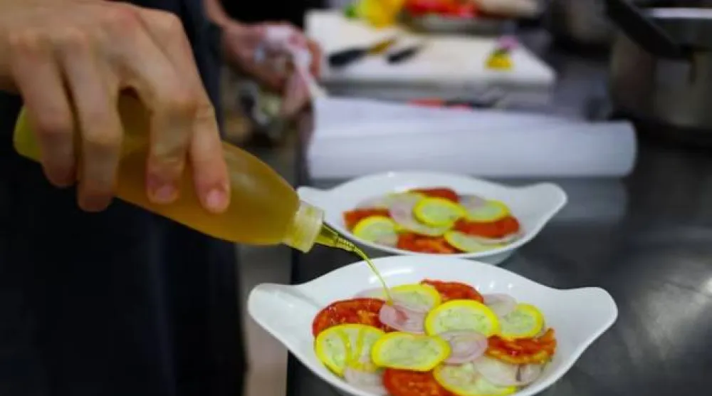 طباخ يحضر الأطباق في مطعم باريسي (رويترز)