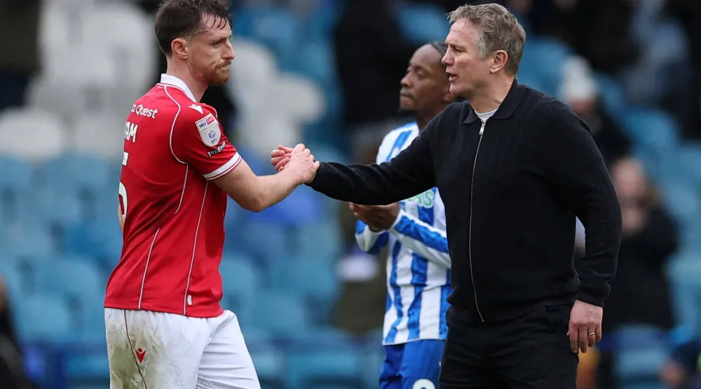 FILE PHOTO: Soccer Football - Championship - Sheffield Wednesday v Wrexham - Hillsborough Stadium, Sheffield, Britain - January 31, 2026 Wrexham's Dominic Hyam and manager Phil Parkinson celebrate after the match Action Images/Andrew Boyers
