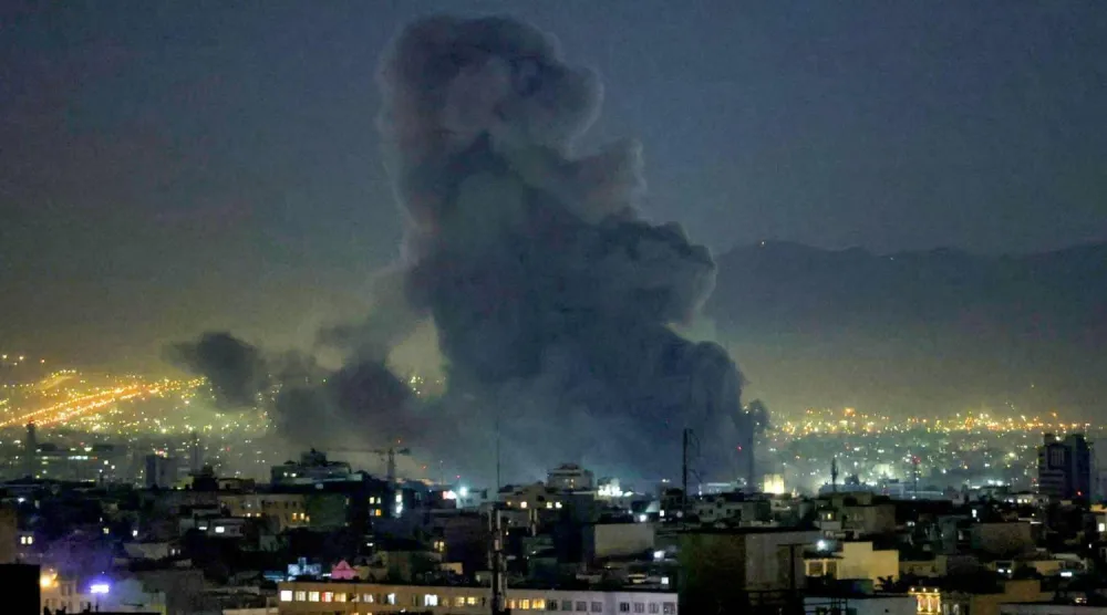 Smoke columns in the sky of the Iranian capital Tehran after the bombing operations (AFP)