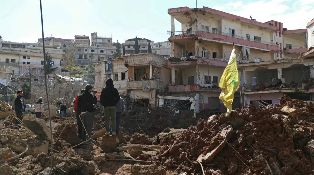 علم لـ«حزب الله» في أحد المواقع التي استهدفها القصف الإسرائيلي في بلدة النبي شيت في بعلبك (أ.ف.ب)
