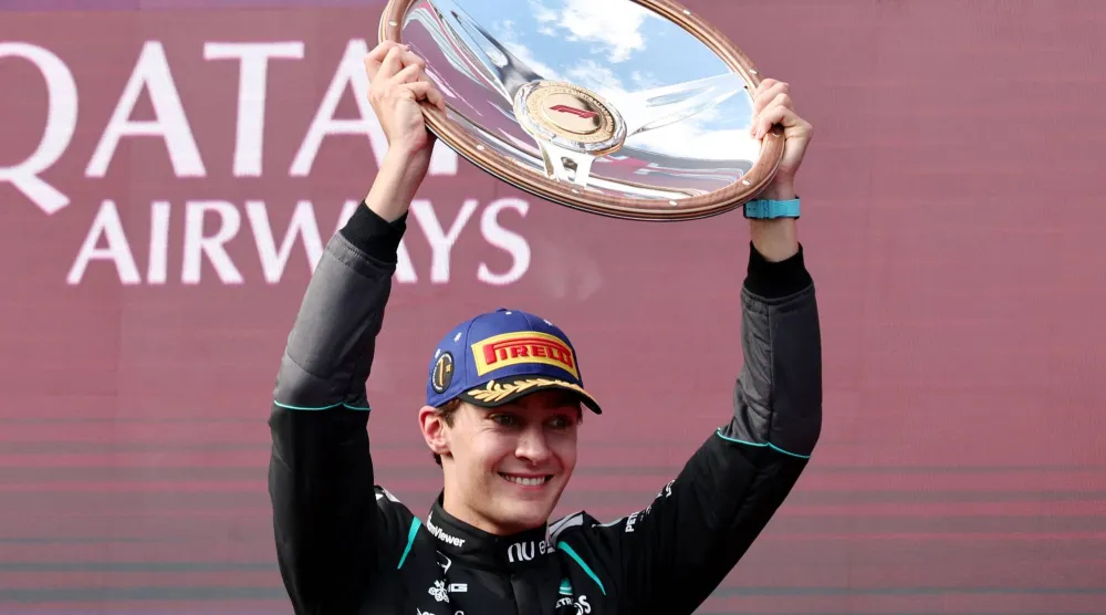 Formula One F1 - Australian Grand Prix - Albert Park Grand Prix Circuit, Melbourne, Australia - March 8, 2026 Mercedes' George Russell celebrates with the trophy on the podium after winning the Australian Grand Prix REUTERS/Mark Peterson