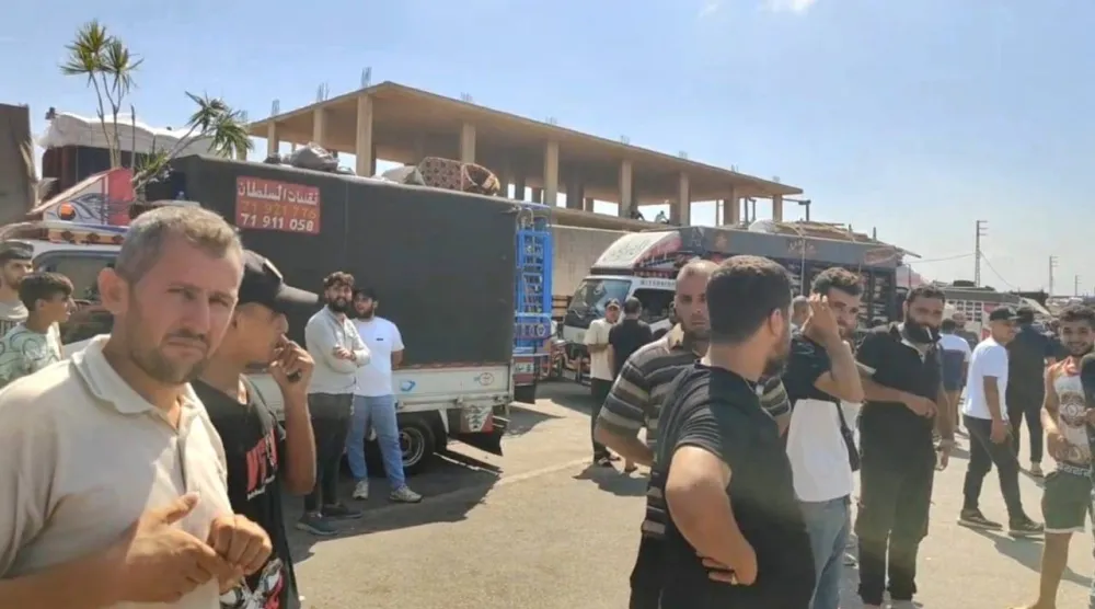 سوريون ينتظرون على معبر «العريضة» خلال رحلة العودة إلى سوريا (متداولة)