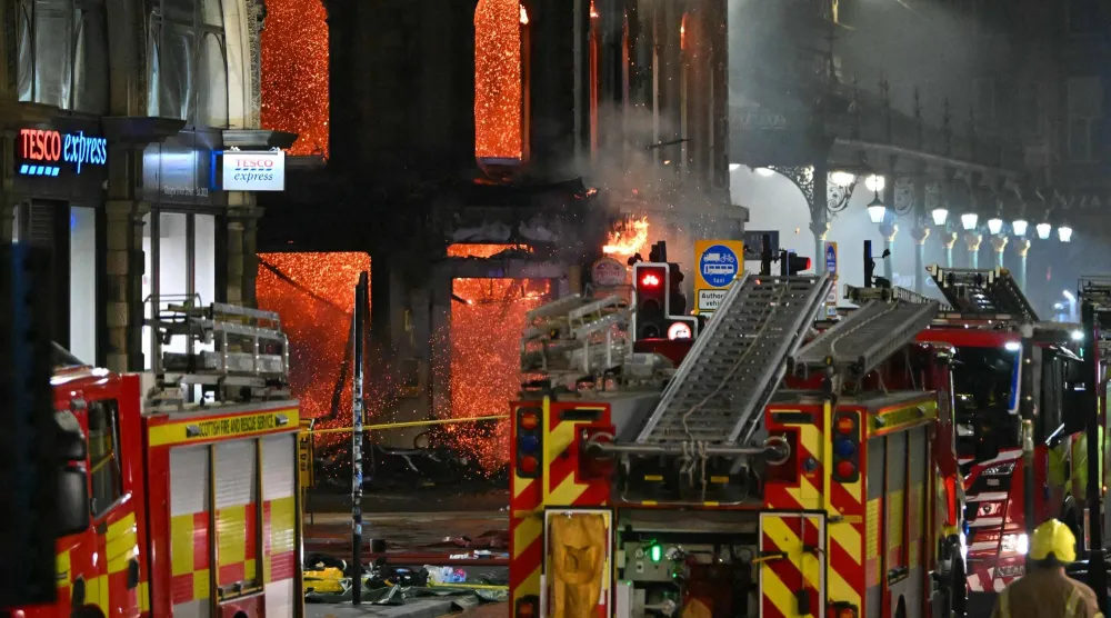  Floors collapse inside the building as fire fighters work at the site of a large fire in Glasgow City center on March 8, 2026. (AFP) 