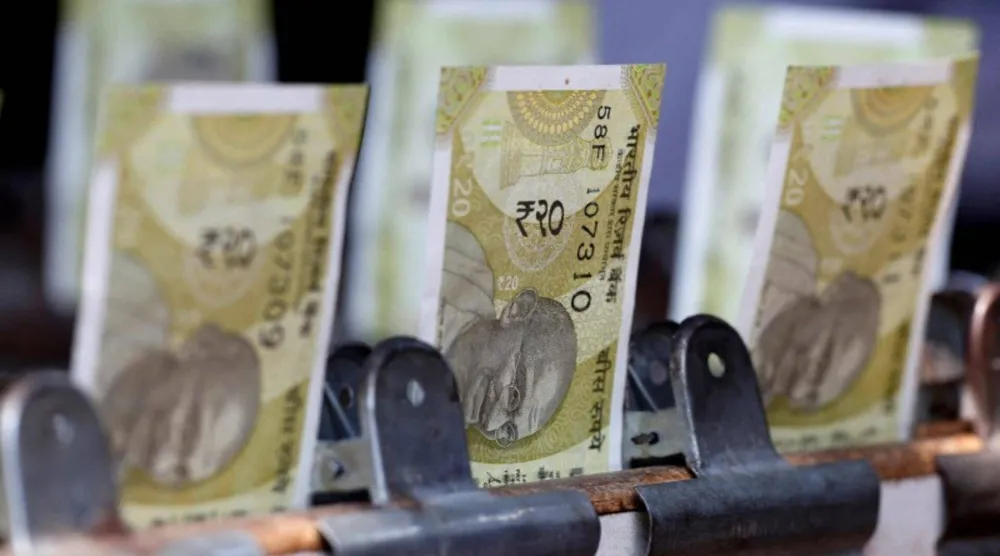 تُعرض أوراق نقدية من فئة 20 روبية هندية في كشك لتبديل العملات على جانب الطريق في نيودلهي (رويترز)