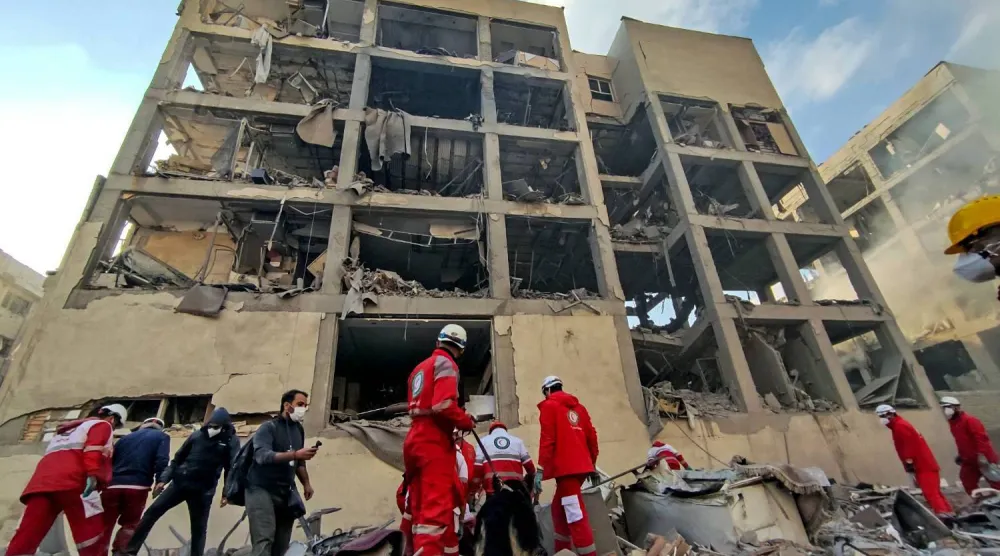  10 March 2026, Iran, Tehran: Members of the Iranian Red Crescent Society (IRCS) rescue teams work at the site of a building damaged in a US-Israeli airstrike in Resalat Square. (dpa)