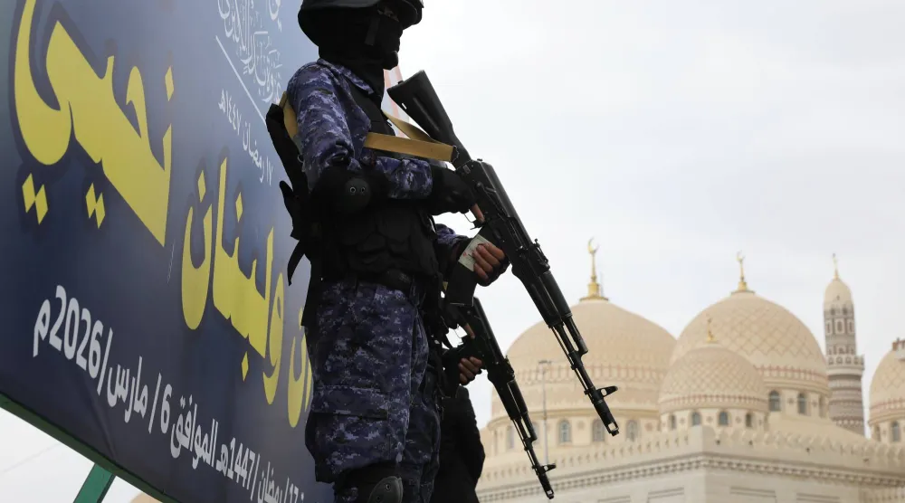 عنصر حوثي يحرس مظاهرة في العاصمة اليمنية المختطفة صنعاء لدعم إيران (إ.ب.أ)