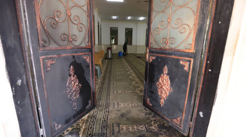 فلسطيني ينظف داخل المسجد في دوما (إ.ب.أ)