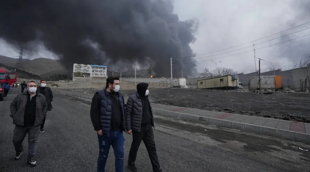 FILE - A thick plume of smoke rises Sunday, March 8, 2026, from an oil storage facility struck overnight in Tehran, Iran. (AP Photo/Vahid Salemi, File)