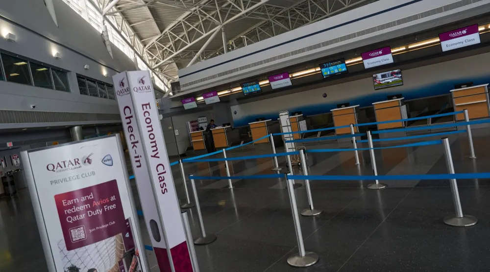 An empty check-in counter for Qatar Airways, amid the US-Israel conflict with Iran, at Terminal 8 at John F. Kennedy (JFK) International Airport in New York City, US, March 2, 2026.  REUTERS/Bing Guan