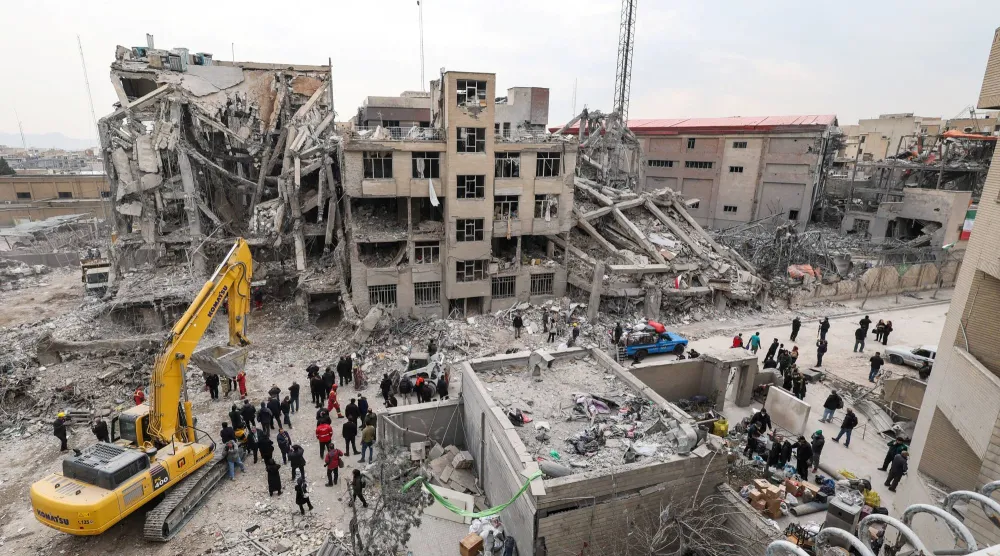 أشخاص يتجمعون في موقع تعرّض لغارة جوية بطهران يوم 12 مارس 2026 (رويترز)