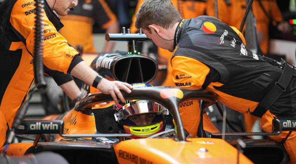 Mechanics work on the car of McLaren's Australian driver Oscar Piastri during the Formula One Chinese Grand Prix at the Shanghai International Circuit in Shanghai on March 15, 2026. (AFP)
