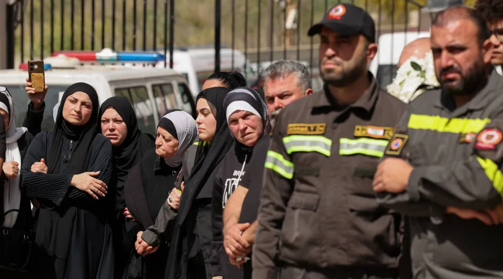 لبنانيون يحضرون تشييع أحد عناصر الدفاع المدني اللبناني بعد مقتله في غارة إسرائيلية على صيدا (رويترز)