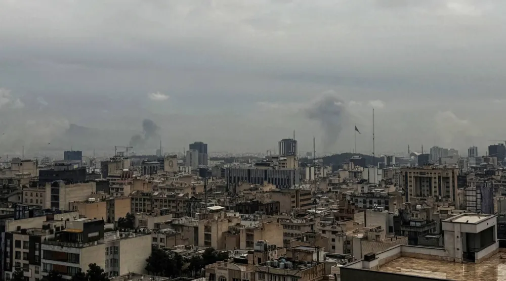 Plumes of smoke rise from the site of a strike in Tehran on March 16, 2026. (AFP)