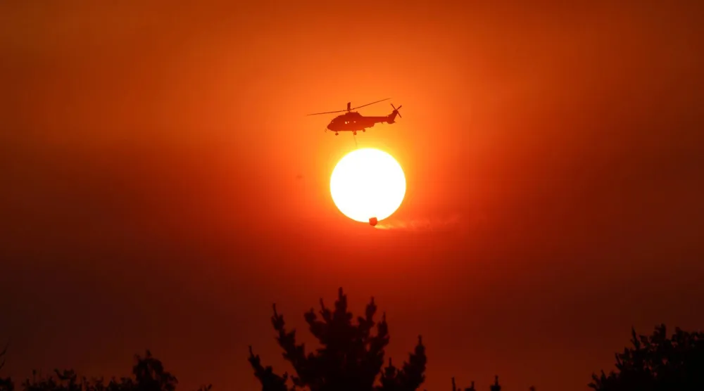 A helicopter battles a forest fire in the Biobio region, where multiple wildfires have prompted emergency evacuations, in Florida, Chile, January 21, 2026. (Reuters)