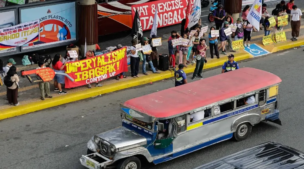 حافلة «جيبني» الشعبية تمر بجانب متظاهرين في مانيلا يعارضون ارتفاع أسعار الوقود المرتبط بحرب إيران (إ.ب.أ)