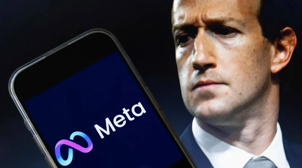 مارك زوكربيرغ الرئيس التنفيذي لـ«ميتا» يظهر بصورة خلف شعار الشركة (أ.ف.ب)