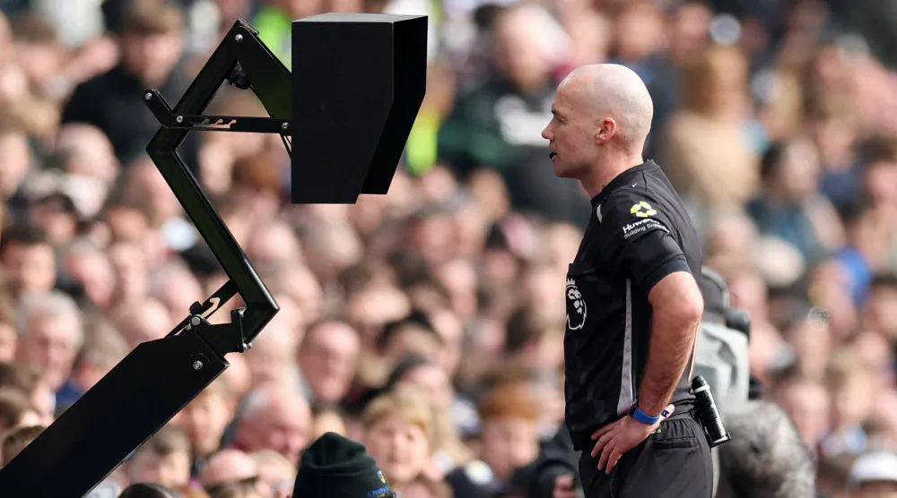 Football - Premier League - Aston Villa v West Ham United - Villa Park, Birmingham, Britain - March 22, 2026 Referee Paul Tierney checks the VAR before overturning an Aston Villa penalty. (Action Images via Reuters) 