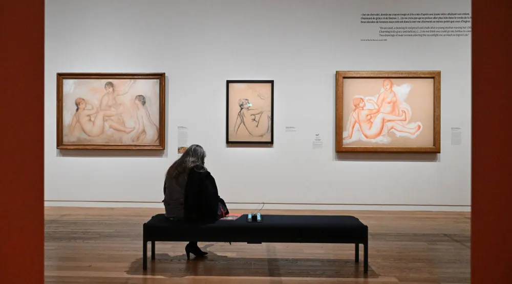 A visitor looks at works by Auguste Renoir during the press review of the exhibition 'Renoir the draughtsman at 'the Orsay museum, Monday, March 16, 2026, in Paris, France. (AP Photo/Emma Da Silva)