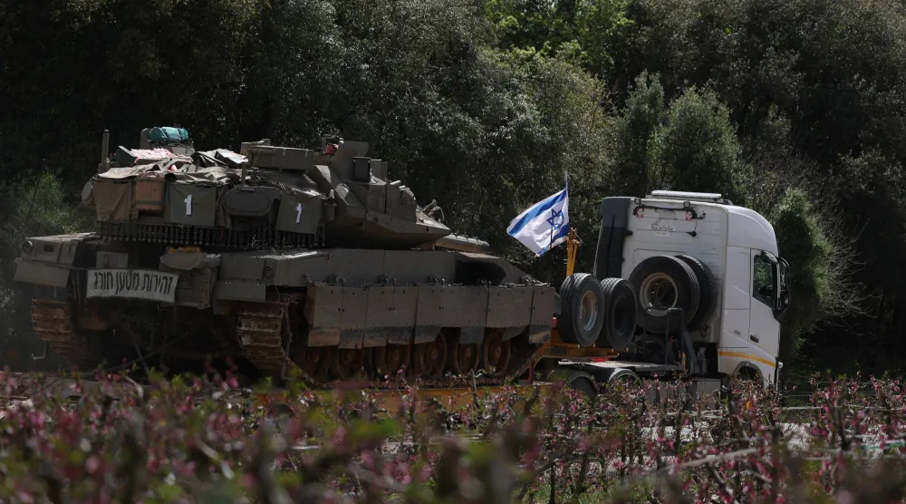 شاحنة محملة بالدبابات تتجه نحو الحدود الإسرائيلية اللبنانية (إ.ب.أ)
