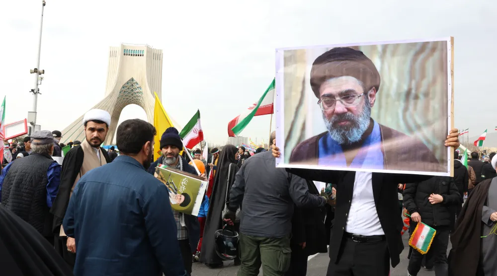 An Iranian man holds a portrait of Mojtaba Khamenei, son of the late Supreme Leader Ali Khamenei, during the 47th anniversary celebrations of the revolution in Tehran, Iran, 11 February 2026. (EPA) 