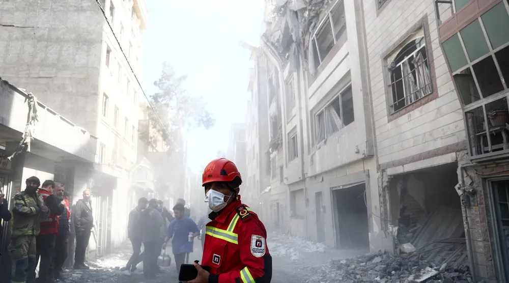 Emergency responders inspect the site of a residential building damaged by a strike, amid the US-Israeli conflict with Iran, in Tehran, Iran, March 27, 2026. Majid Asgaripour/WANA (West Asia News Agency) via Reuters 