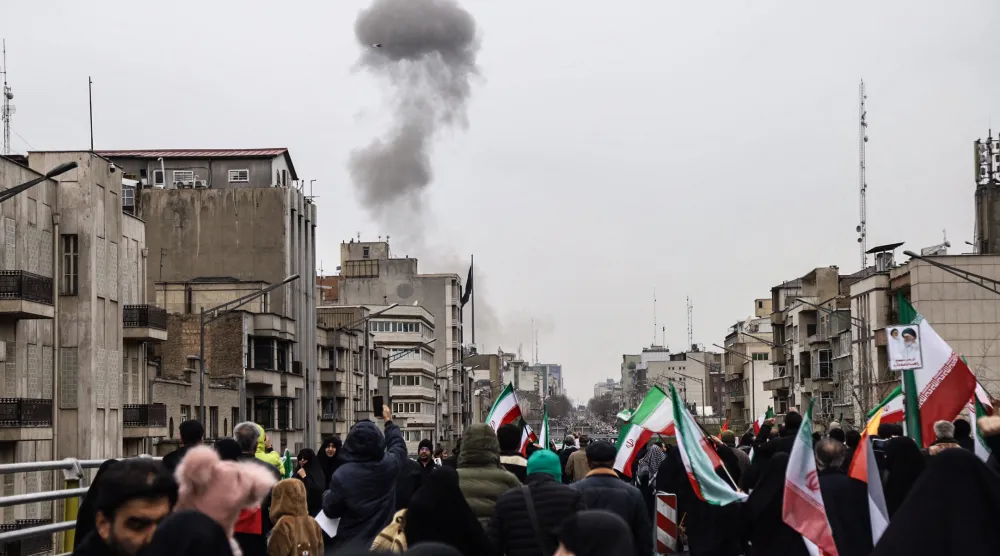 Black smoke rises following an airstrike, as Iranians take part in the Al-Quds (Jerusalem) Day rally, a commemoration in support of the Palestinian people on the last Friday of the Islamic holy month of Ramadan, in Tehran on March 13, 2026. (AFP)