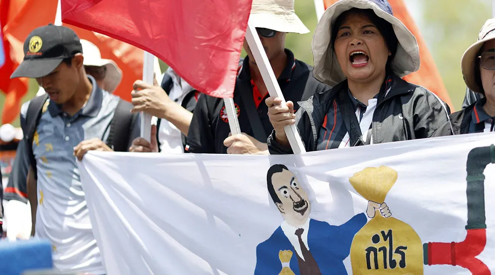 متظاهرون يهتفون بشعارات خلال مظاهرة احتجاجية ضد ارتفاع أسعار الوقود وتكاليف المعيشة أمام مقر الحكومة في بانكوك (إ.ب.أ)