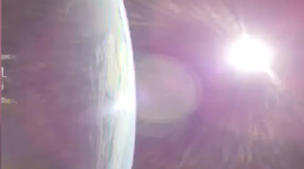 This image taken from video provided by NASA shows the Earth, left, from NASA's Orion spacecraft as it fired its engines heading toward the moon Thursday, April 2, 2026. (NASA via AP)