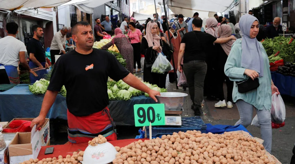 بائع ينتظر الزبائن في سوق طازج بإسطنبول (رويترز)