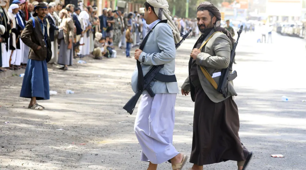 مسلحان حوثيان خلال تجمع في صنعاء للتضامن مع إيران (إ.ب.أ)