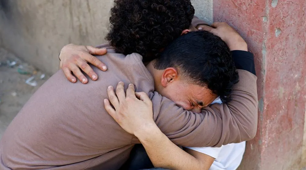  Palestinians react following an Israeli strike outside a school sheltering displaced people, according to medics, at Al-Aqsa Martyrs Hospital in Deir al-Balah in the central Gaza Strip, April 6, 2026. (Reuters)