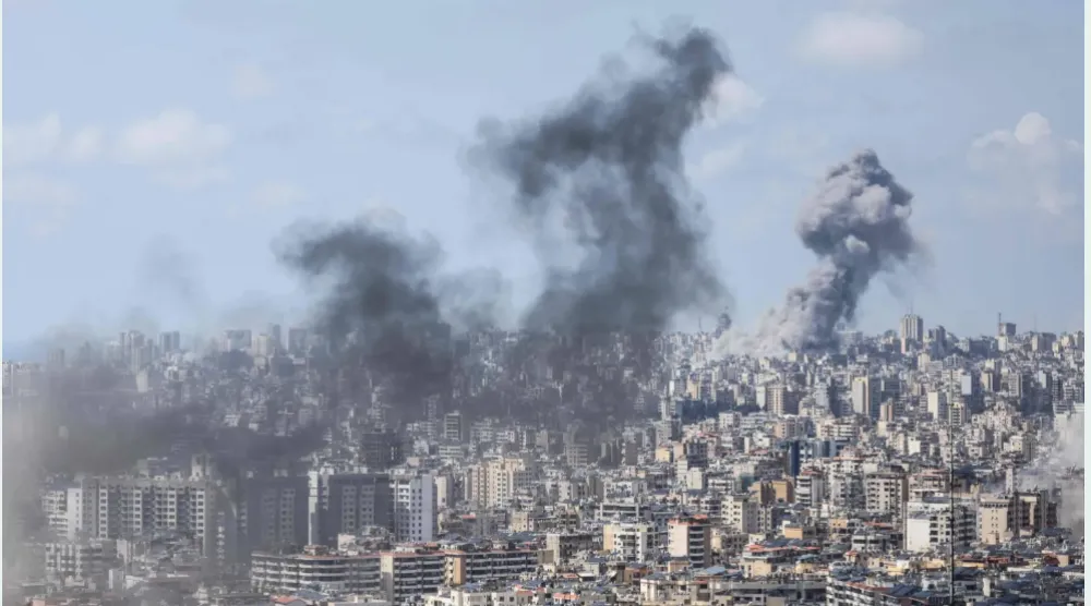 Smoke rising from the sites of Israeli air raids on Beirut and the southern suburb last Wednesday (AFP)