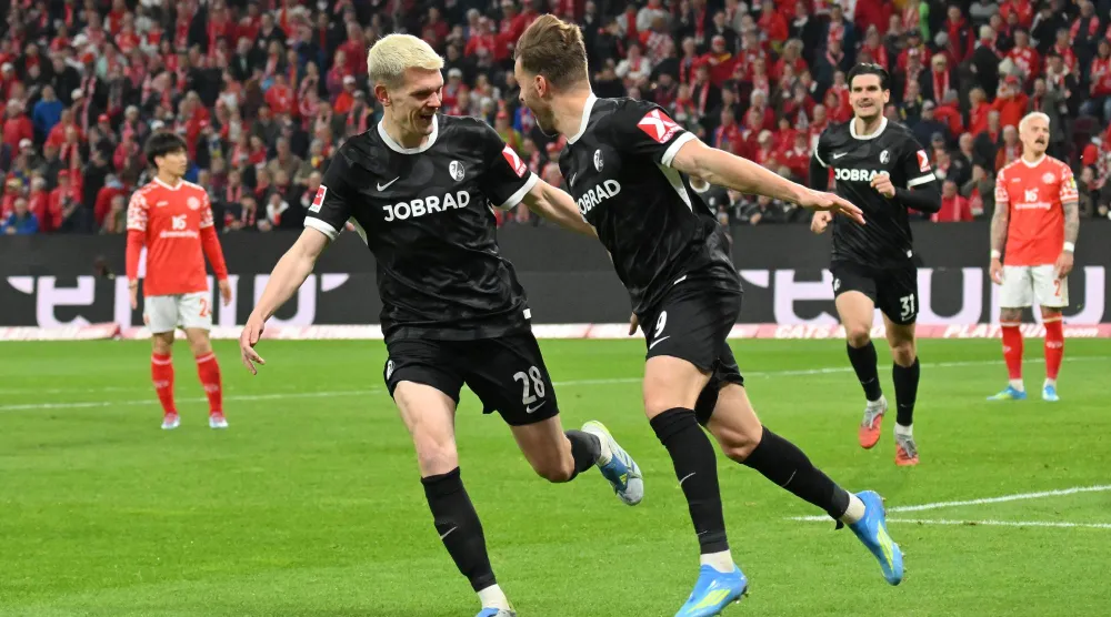 احتفالية لاعبي فرايبورغ بالفوز على ماينز بملعبه (أ.ب)