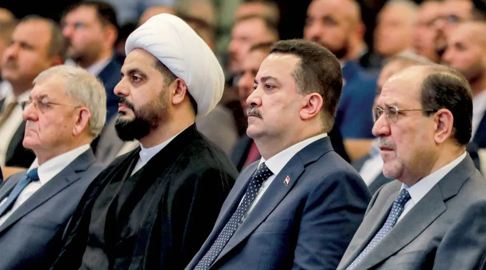  أرشيفية للسوداني متوسطاً المالكي وقيس الخزعلي خلال اجتماع في بغداد (أ.ف.ب)