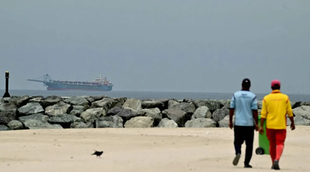A ship is seen in the Gulf off the coast of Sharjah the day after the failure of US-Iran peace talks on April 13, 2026. (AFP)