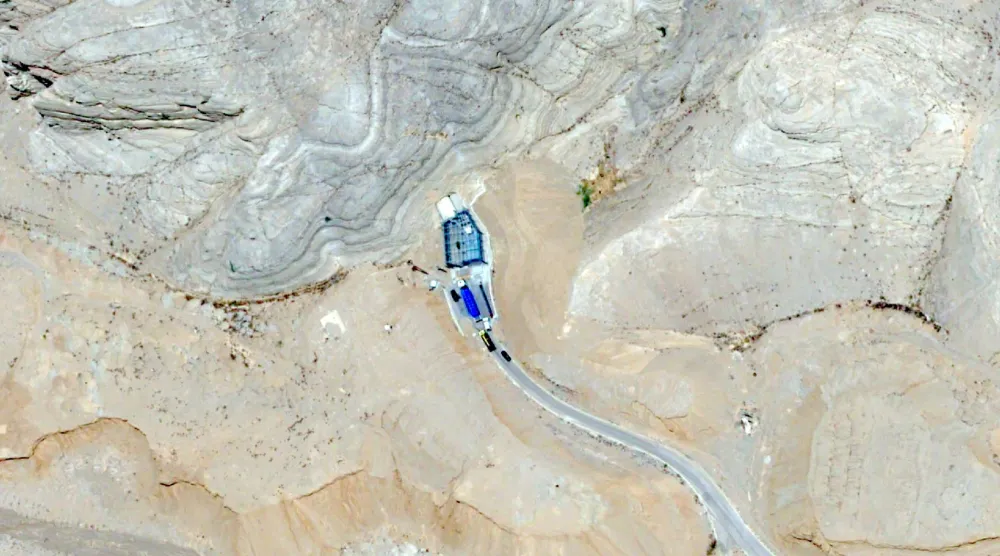 تُظهِر هذه الصورة الملتقَطة بواسطة القمر الاصطناعي «بلياديس نيو» التابع لشركة «إيرباص للدفاع والفضاء» شاحنة محمَّلة بـ18 حاوية زرقاء تنقل يورانيوم عالي التخصيب تدخل إلى نفق داخل مجمع «مركز التكنولوجيا النووية» في أصفهان 9 يونيو 2025 (أ.ب)