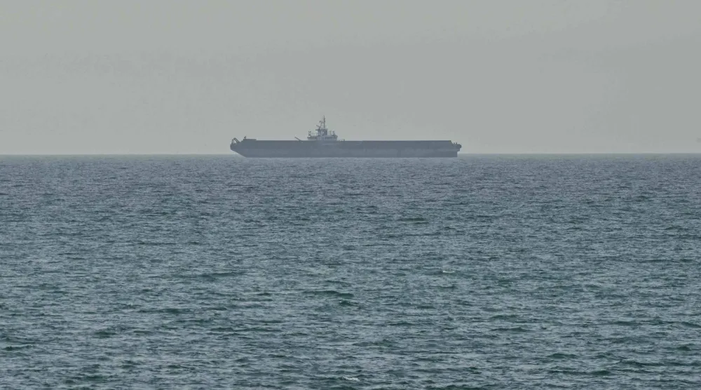 A ship is seen off the coast of Ras al-Khaimah, the day after the failure of US-Iran peace talks on April 13, 2026. (AFP)